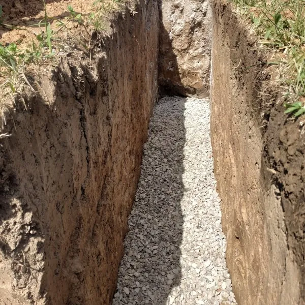 Drenážní příkop s kámen kolem domu