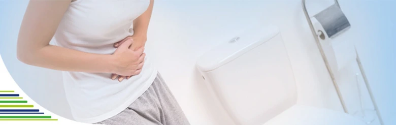 Woman holding stomach in bathroom