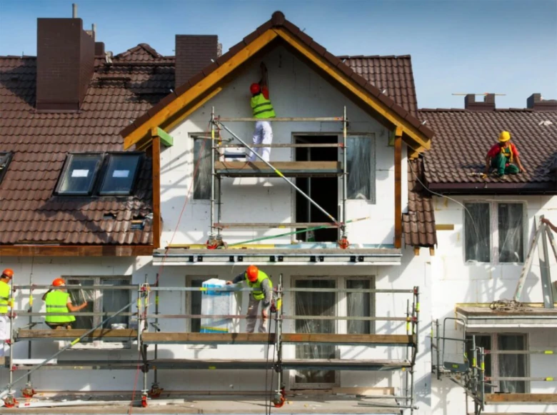 House renovation workers on scaffolding
