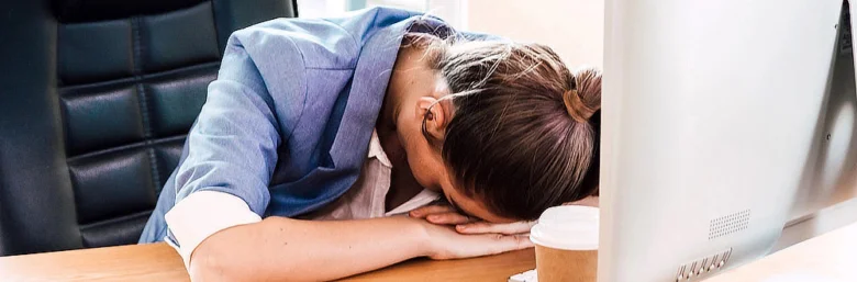 Woman sleeping at desk