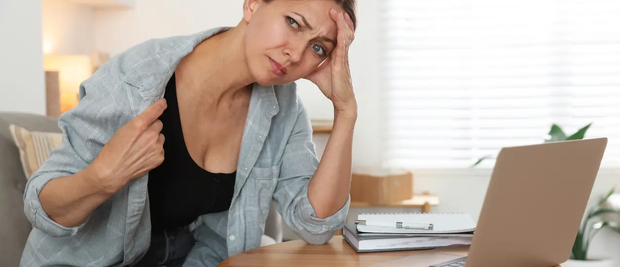 Woman feeling unwell at desk