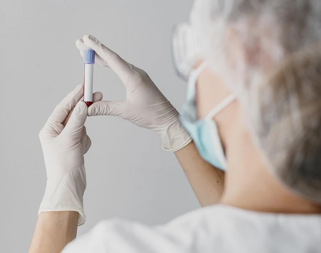 Medical professional holding test tube