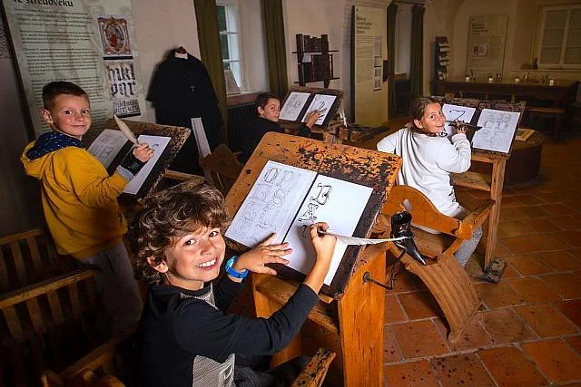 Children drawing in monastery schoolroom